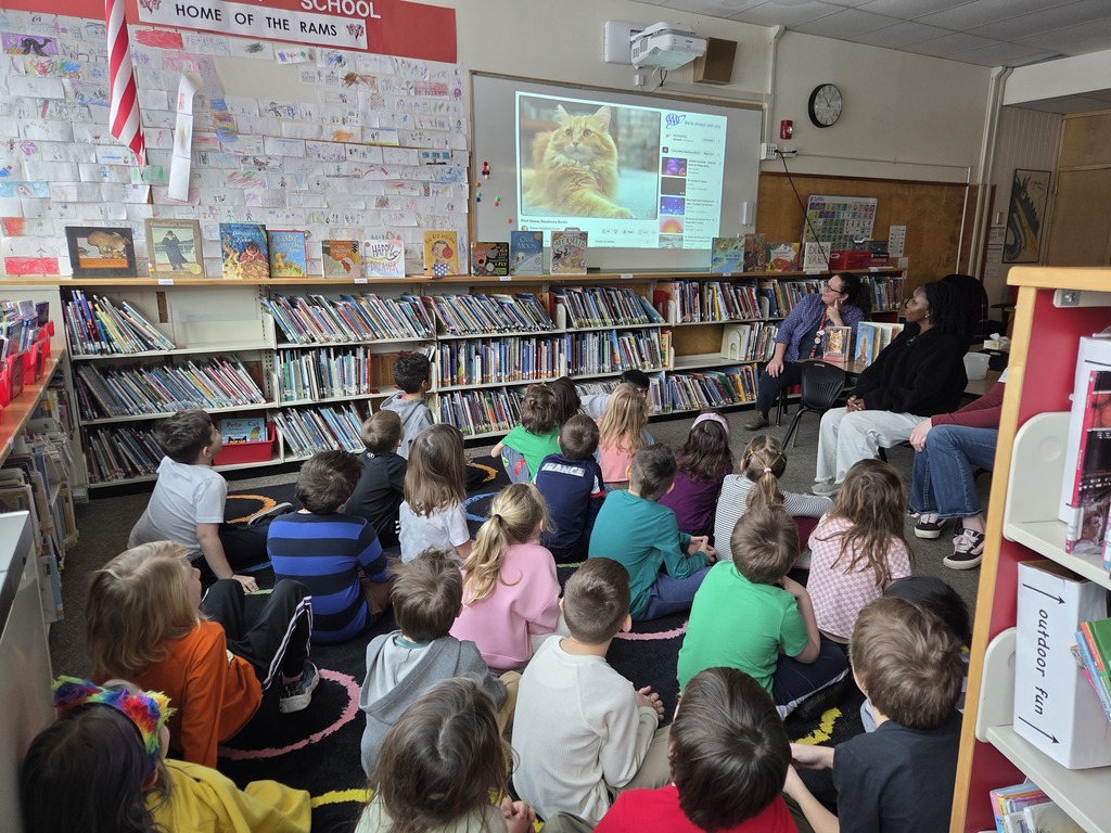 Members of the BHS Library Book Club visited two first-grade classes at Fourteenth Street, guided by Librarian Ms. Sprague. The purpose of the visit was to read aloud to the children and carry out a craft activity. They shared the book Dewey: There's a Cat in the Library by Vicki Myron and Brett Witter, which tells the heartfelt story of a real cat. As a kitten, Dewey was unfortunately dropped into a library's book return dropbox one night in Spencer, Iowa. The librarians decided to adopt him as the "library cat," allowing patrons to interact with him over the years. After the reading session, the first graders enjoyed coloring, cutting, and assembling their own library cats to take home and read to.