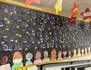 At Fruit Street School, Mrs. Libby has made it a yearly tradition to engage her students in crafting a mesmerizing hallway mural themed around kindness. Using art as a powerful tool, she sparks awareness, emotion, and connection, ultimately aiming for positive change within the school community.