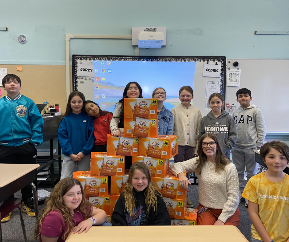 Fairmount Soar Store students stand proudly with boxes of snacks for their fellow students.
