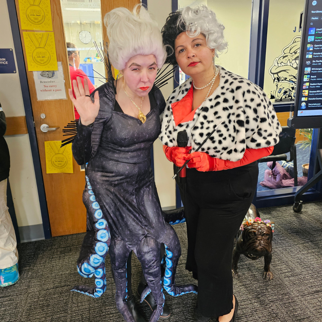 Staff dressed as Ursula and Cruella