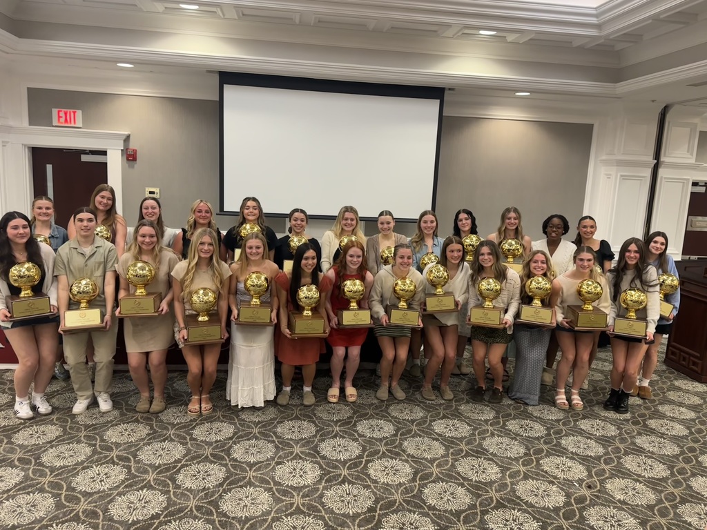 Members of the BHS State Championship Girls Soccer team holding their Gold Ball Trophies at their banquet.