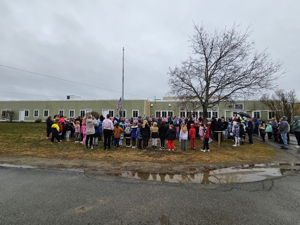 Students gather around the flagpole in front of Downeast School to kick off Camp Read A-Lot activities.