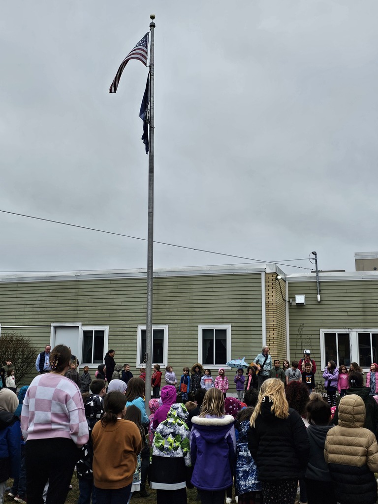 Students gather around the flagpole in front of Downeast School to kick off Camp Read A-Lot activities.