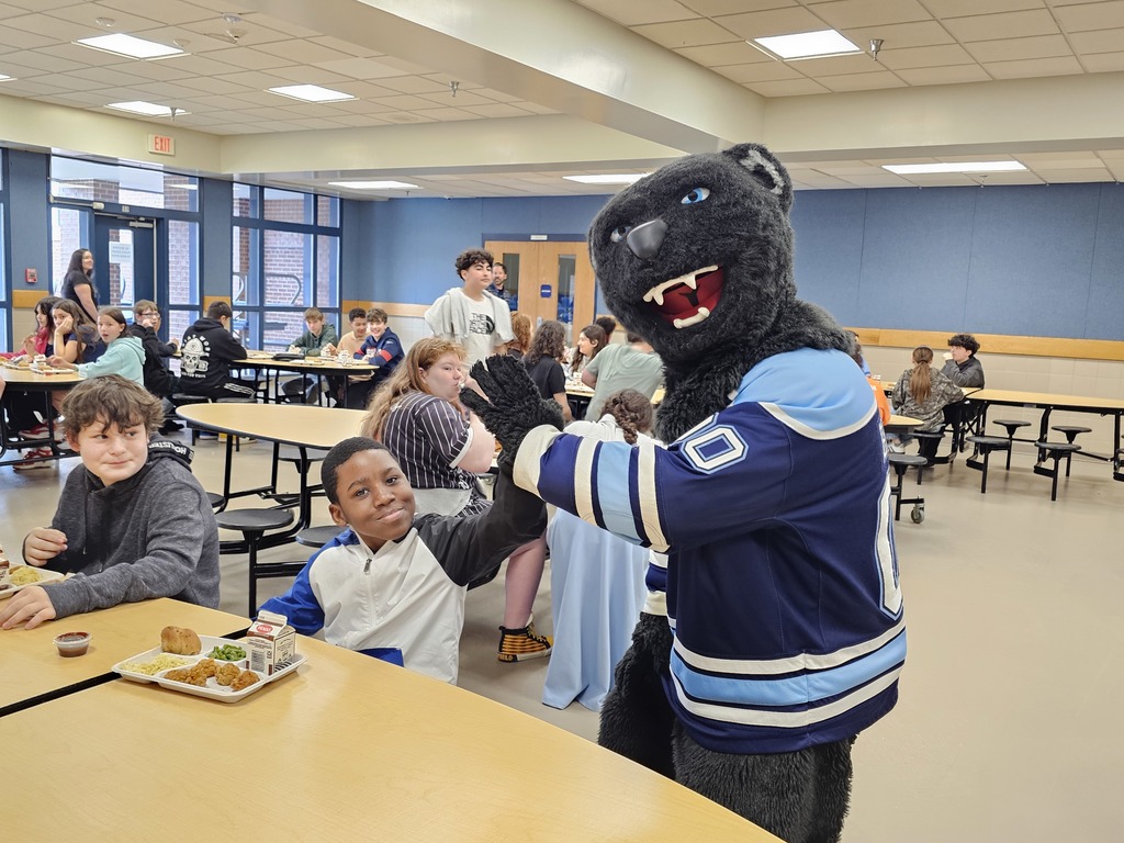 Bananas the Bear giving high fives during lunch