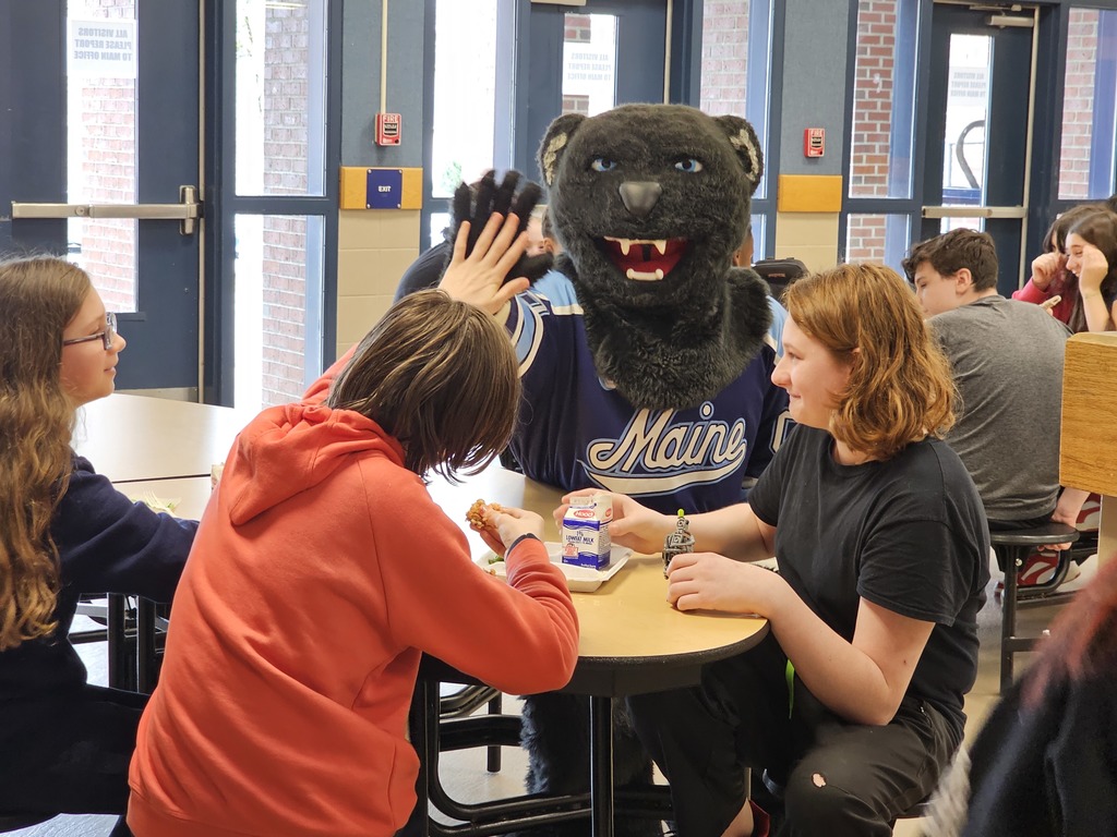 Bananas the Bear giving high fives during lunch