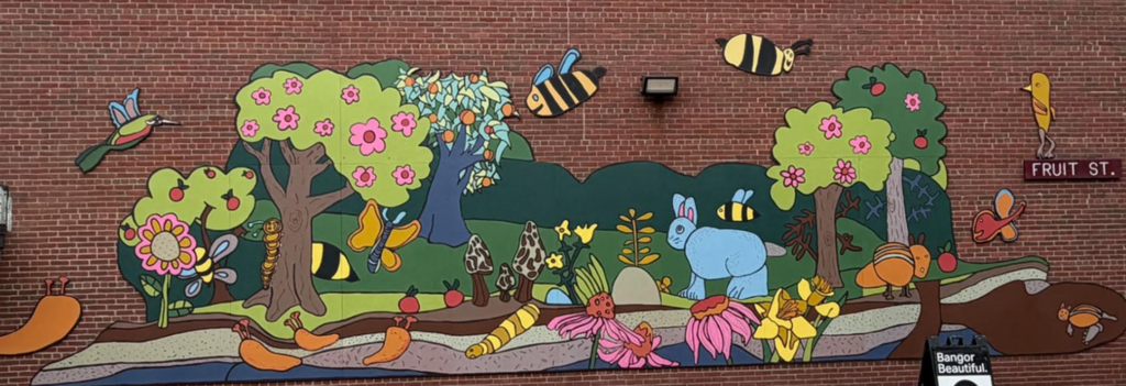 The new Fruit Street mural is a colorful and whimsical celebration of nature, pollinators, and the fruit trees that help our ecosystem thrive. This project was truly a community effort. Each Fruit Street student learned about the important role pollinators play and created the artwork that inspired the mural's design. Over the past week, students rolled up their sleeves and helped paint the mural alongside Bangor High School art students, teachers, and volunteers. A special thank you to Bangor Beautiful and Maine artist Peter Walls, who brought all of the student-created elements together into one beautiful final design. This weekend, Peter, his son, Bangor Beautiful volunteers, and Principal Fournier completed the installation, giving the school a lasting piece of art that reflects creativity, learning, and community pride. Be sure to stop by and admire this vibrant new addition to Fruit Street!