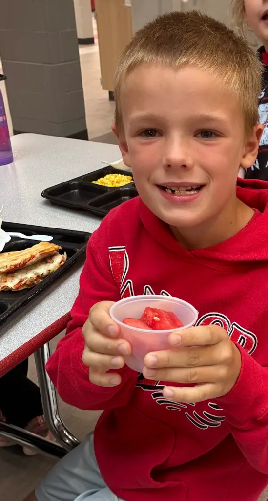 Child with watermelon serving