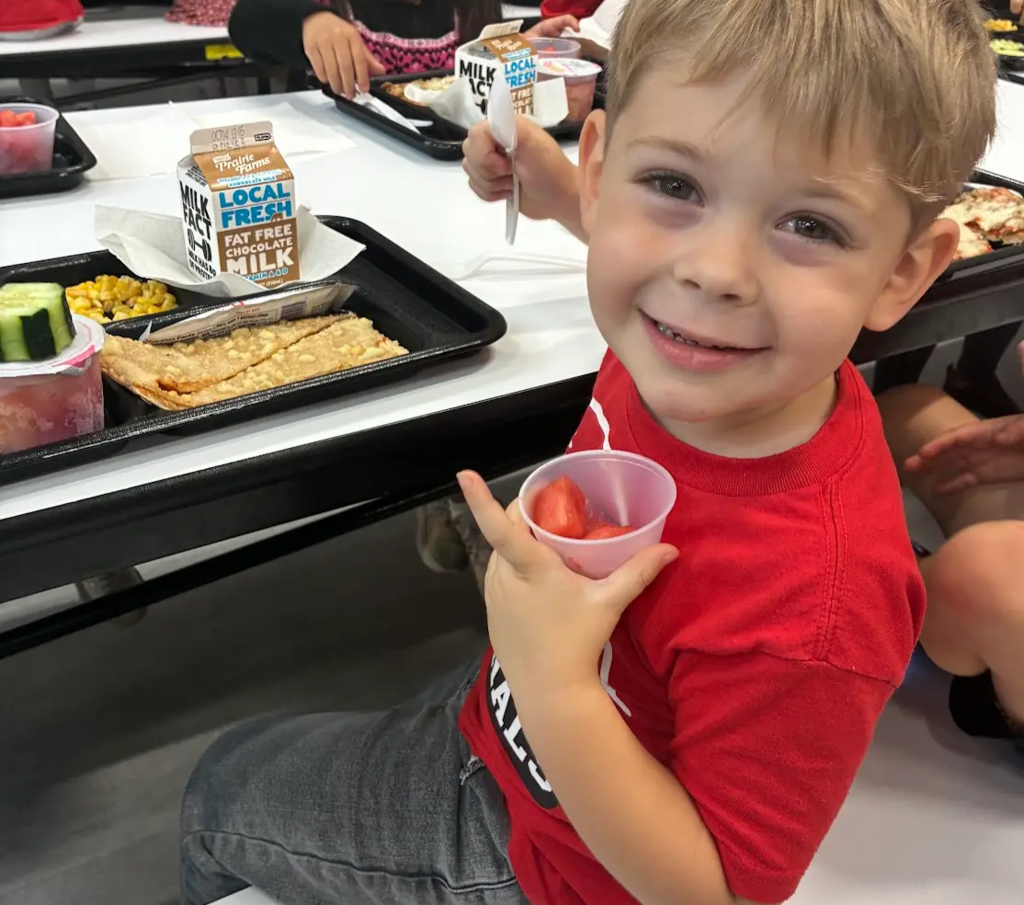 Child with watermelon serving