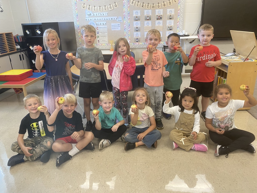 Students with fresh apples.