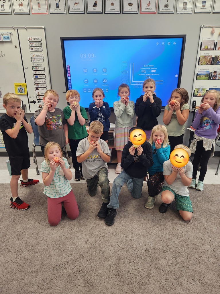 Students enjoying fresh apples.