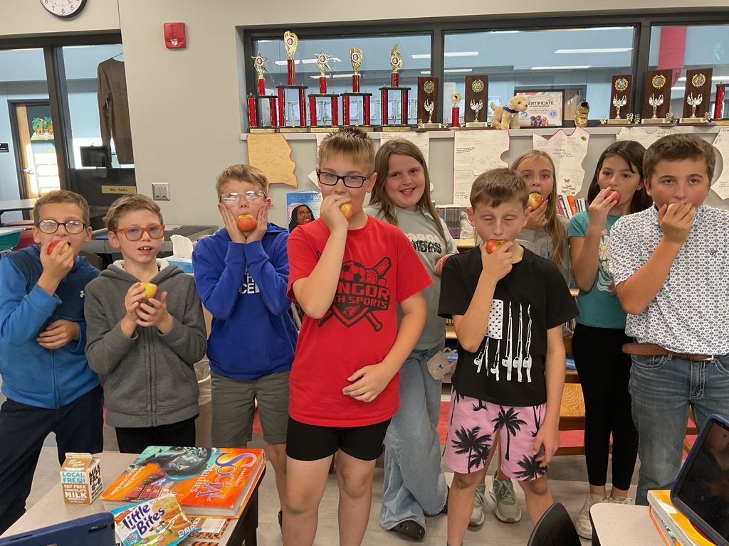Students enjoying fresh apples.