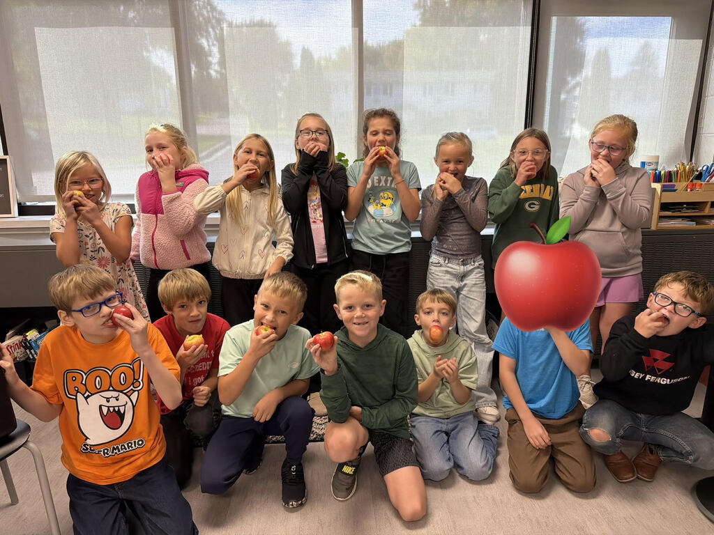 Students enjoying fresh apples.