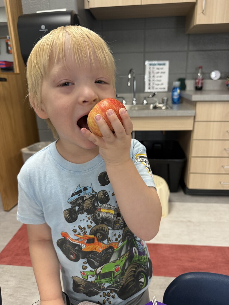 Boy eating apple.