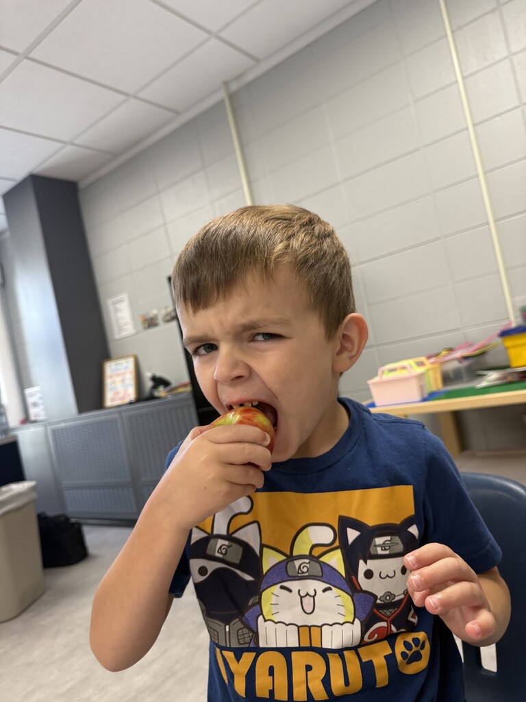 Boy eating apple.