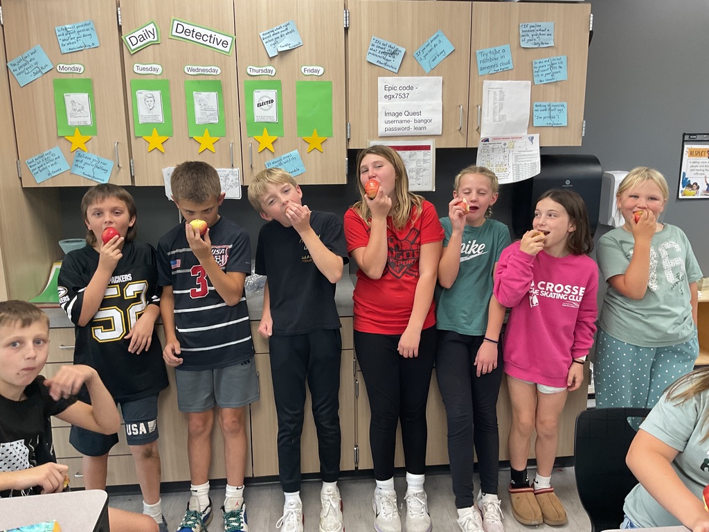 Students enjoying fresh apples.