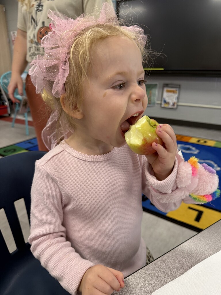 Girl eating apple.