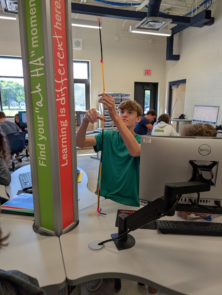 photo of student building a straw structure