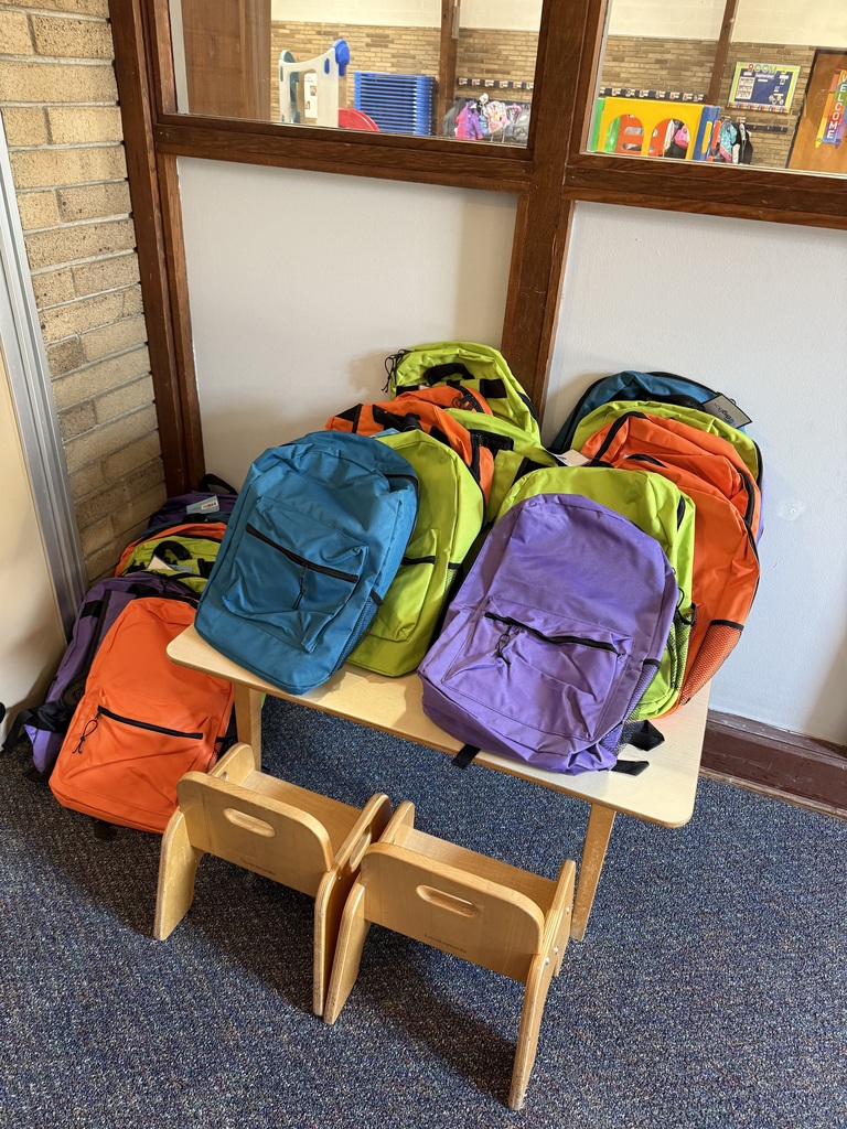 photo of colorful backpacks on a table