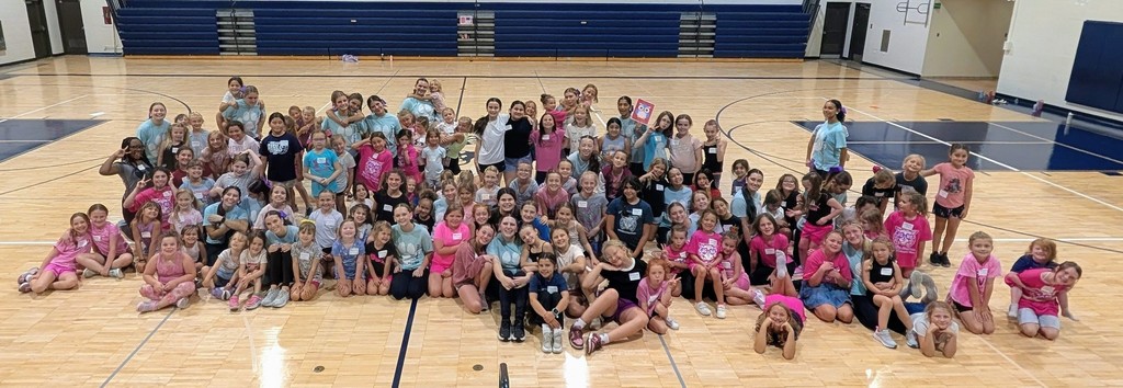 large group of mini pommers with high school pom pon team athletes 