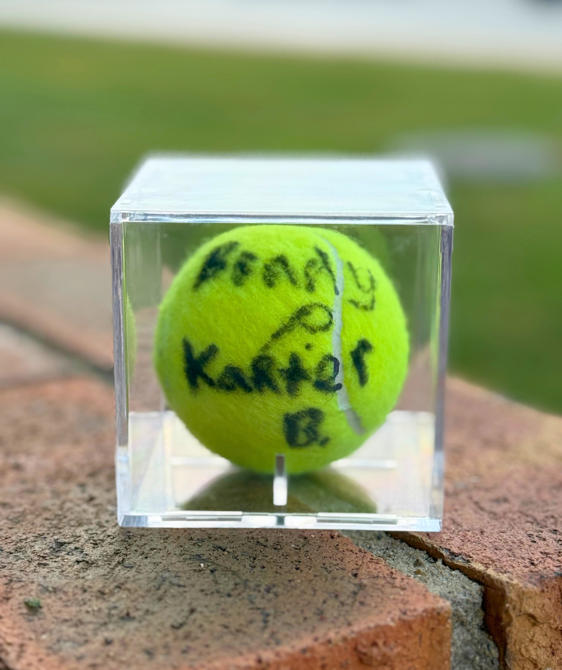 photo of signed tennis ball in case