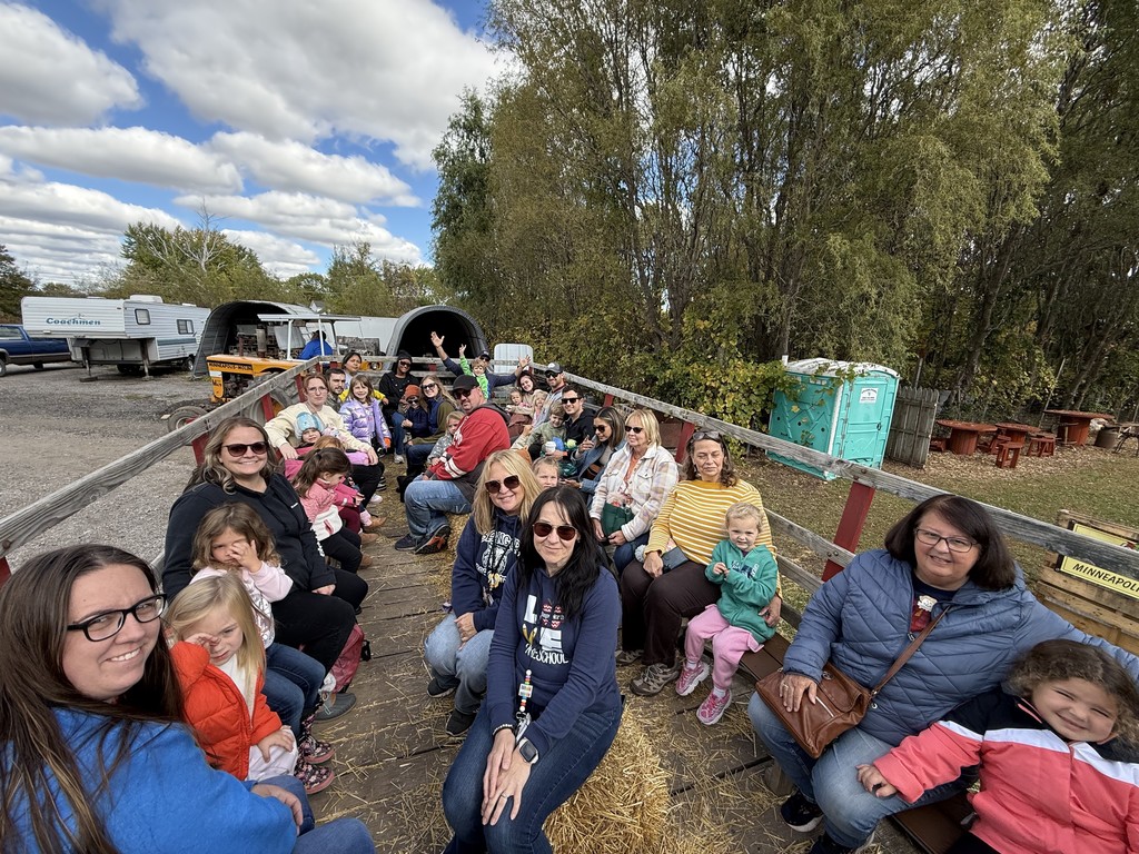 group of kids and teachers on a hay ride