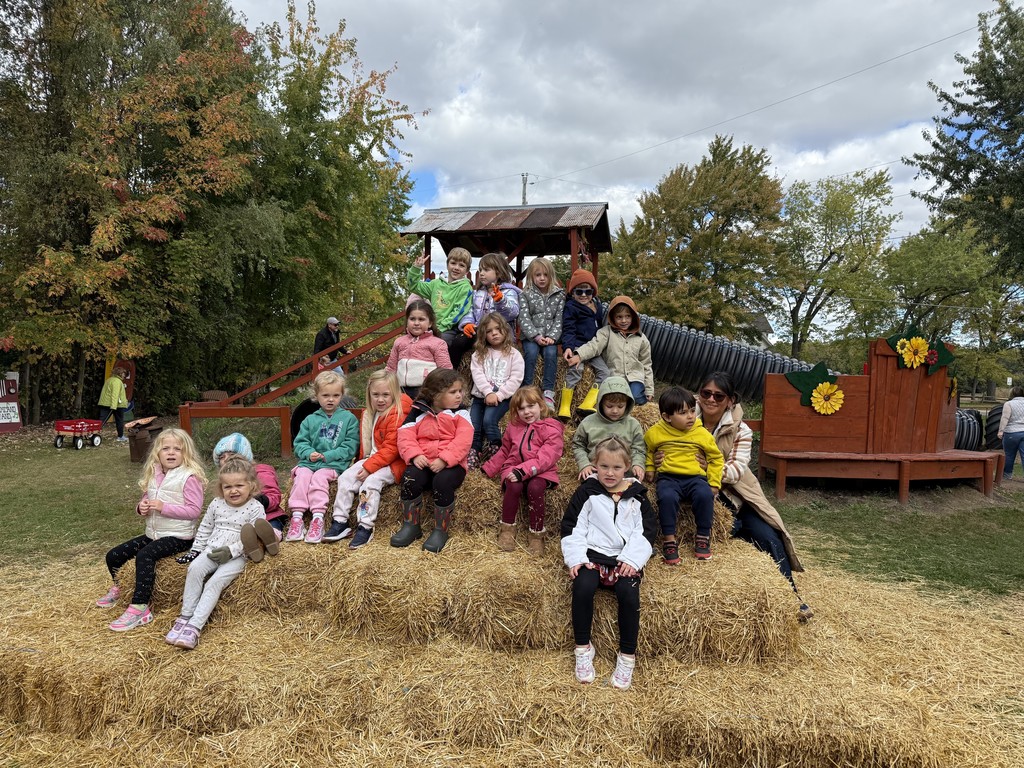 group of kids on straw bales