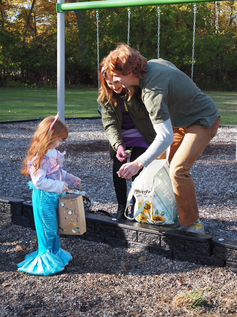 adults handing out candy