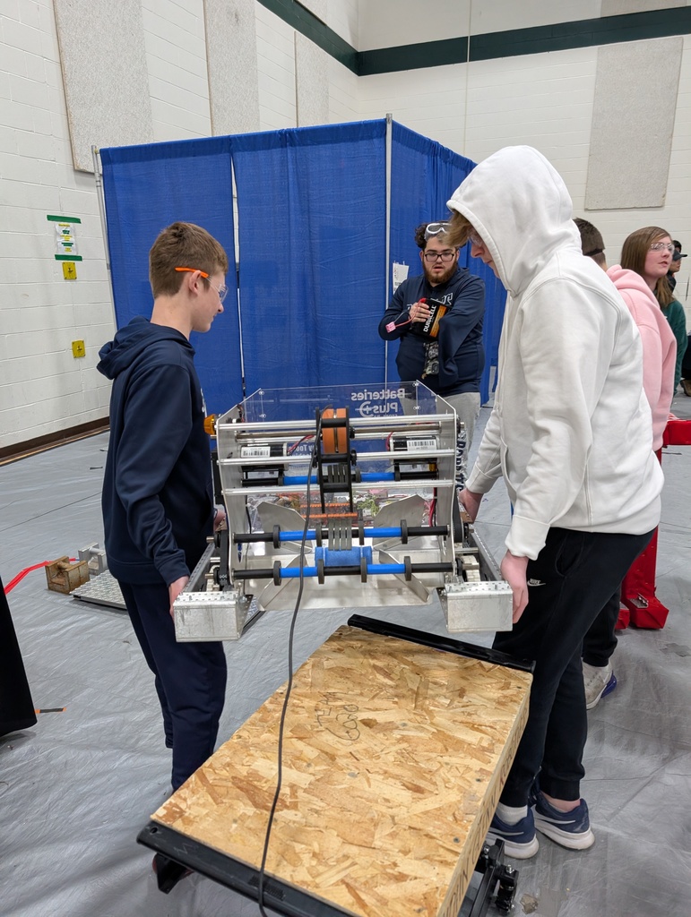 robotics students lifting a robot