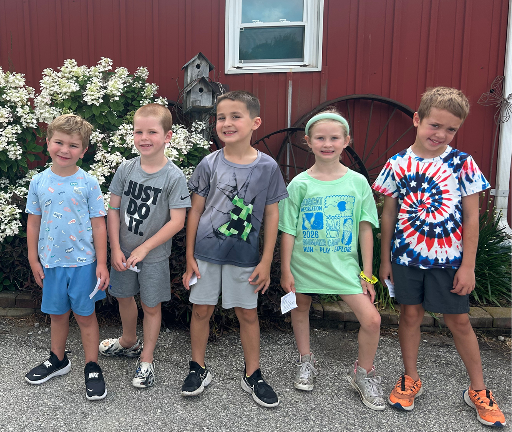 group of five students smiling for a photo
