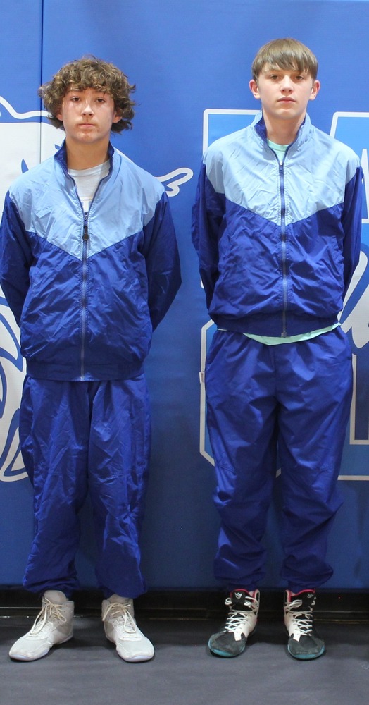 2 wrestlers standing for a picture