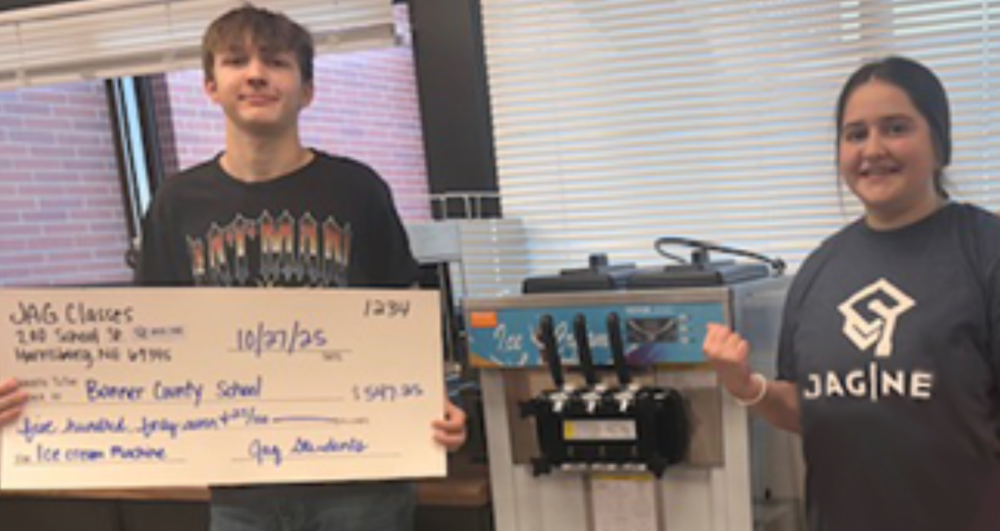 Students holding a Check