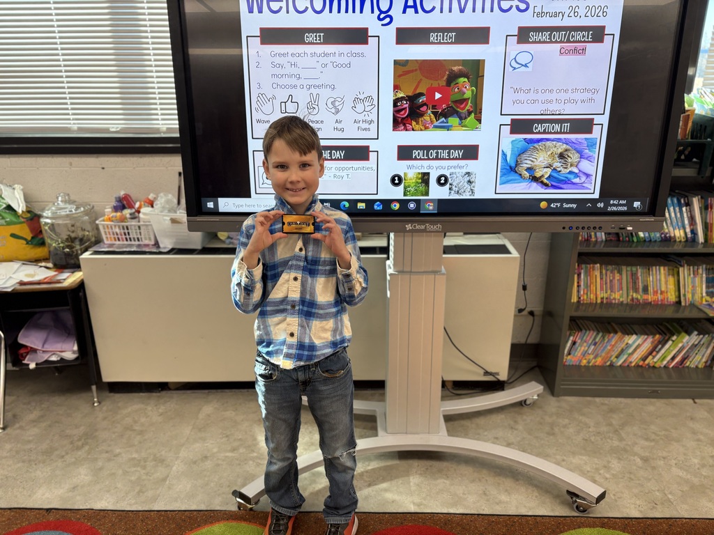 Student holding a prize for reading