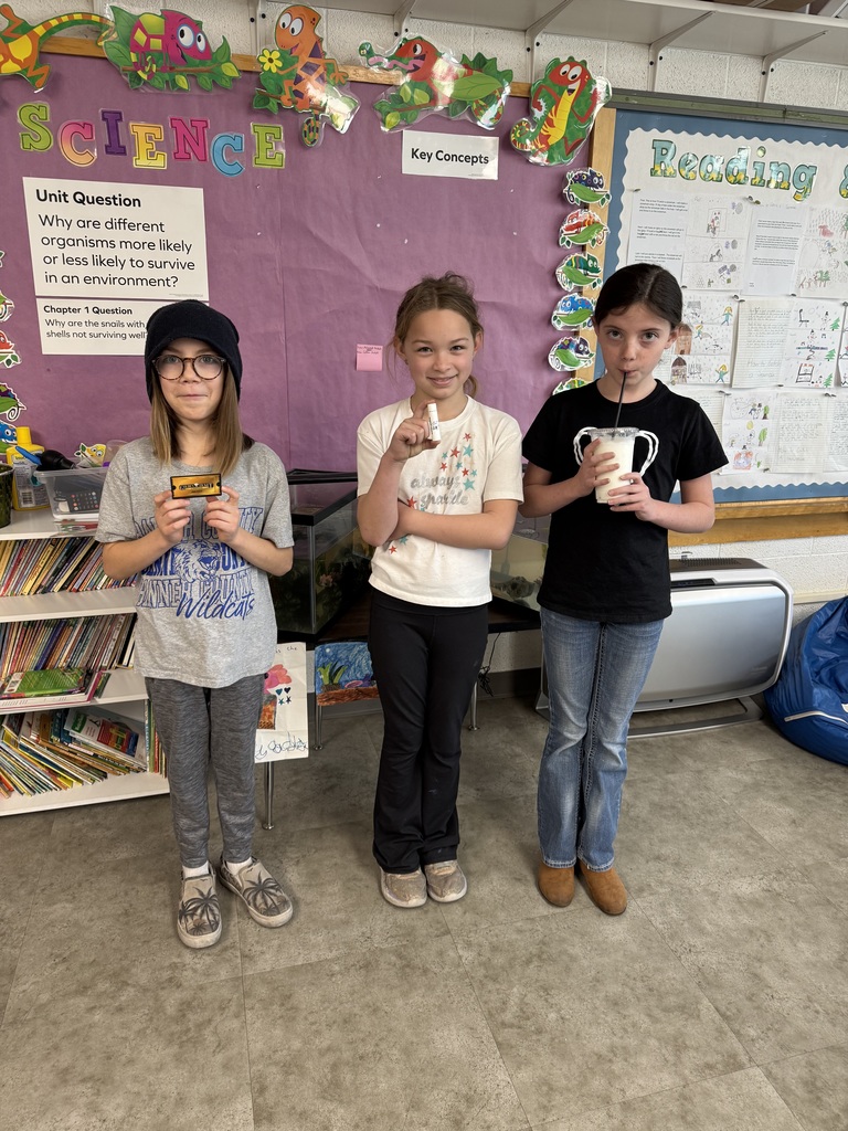 Students holding prizes for reading