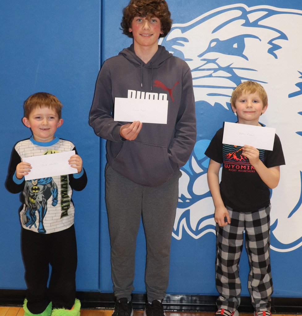 Three Students holding awards for being names as Students of the Month 