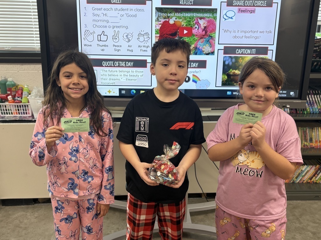 Students holding a prize for reading