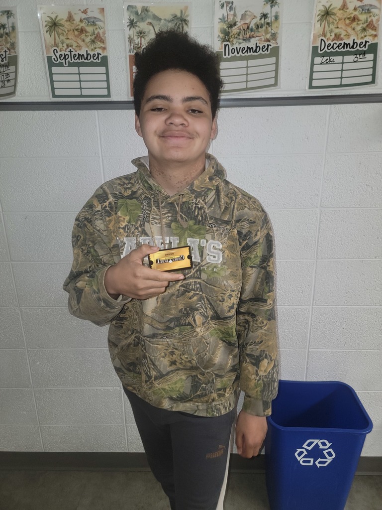 Student holding a prize for reading