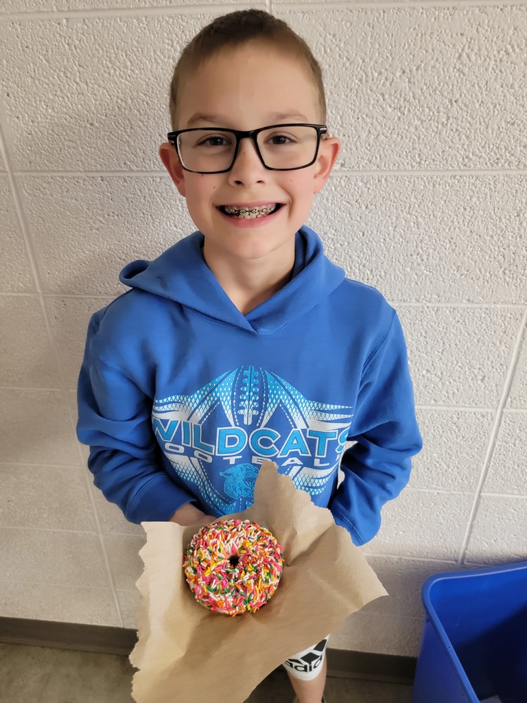 Student holding a prize for reading