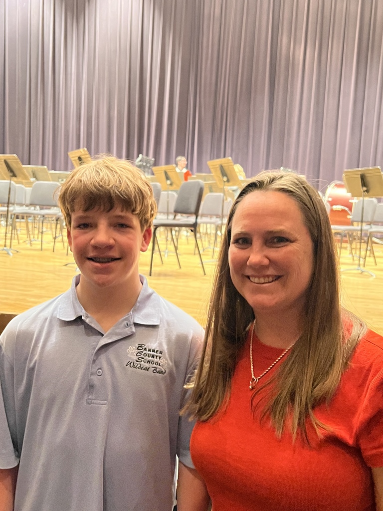 Student with teacher at band concert 
