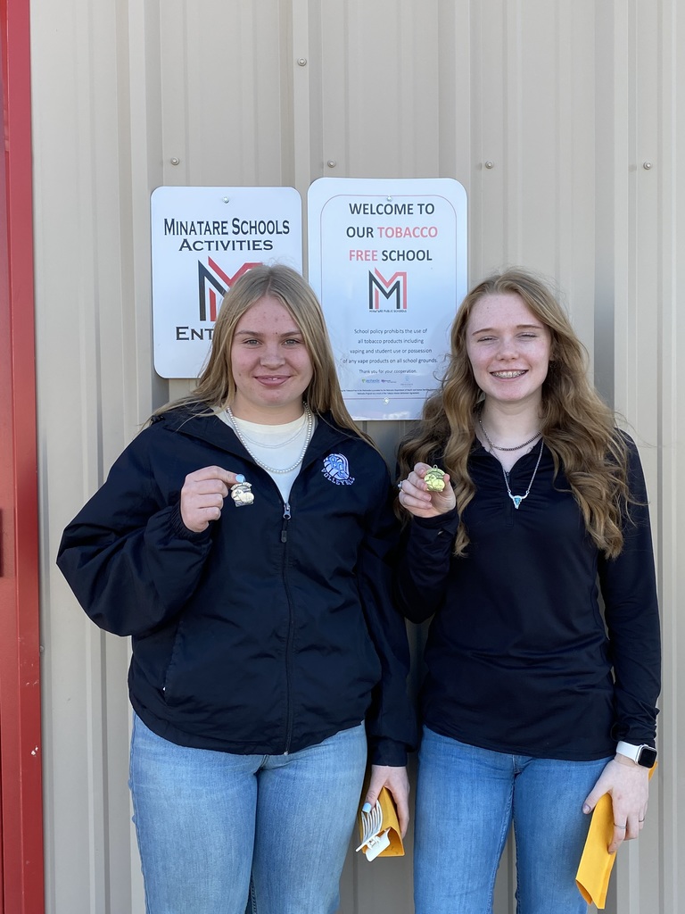 Two students holding medals 