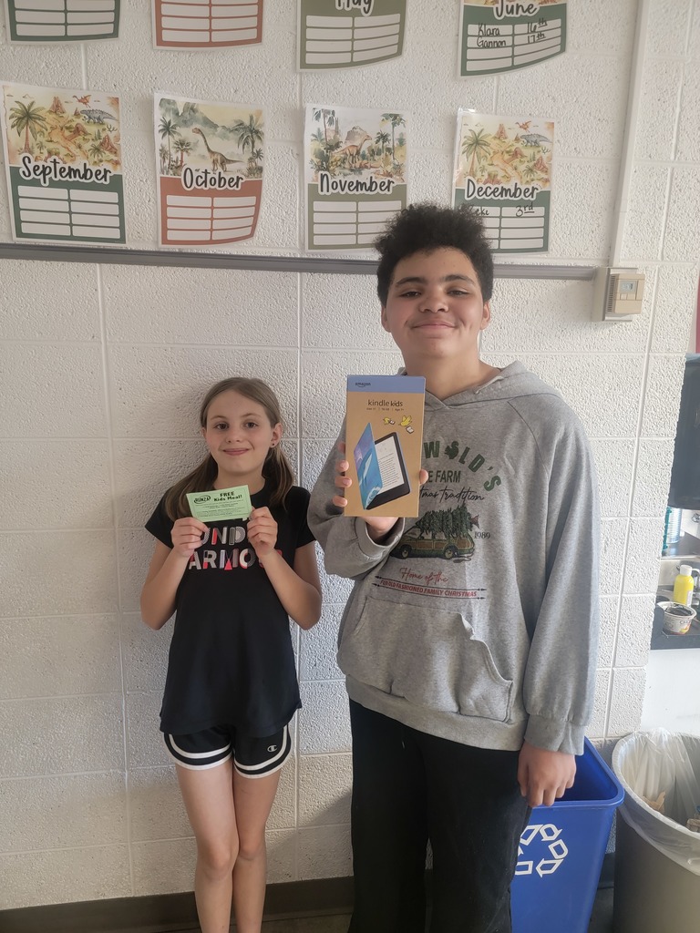 Student holding a prize for reading