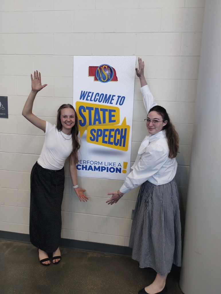 Students in front of a state speech sign 