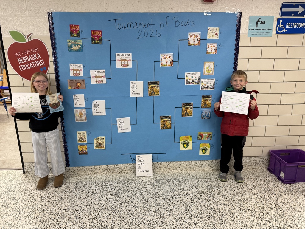 Two students standing by a bracket for the book winners