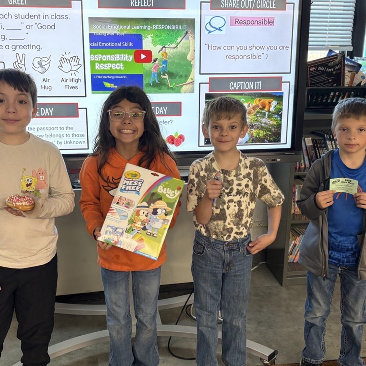 Student holding a prize for reading