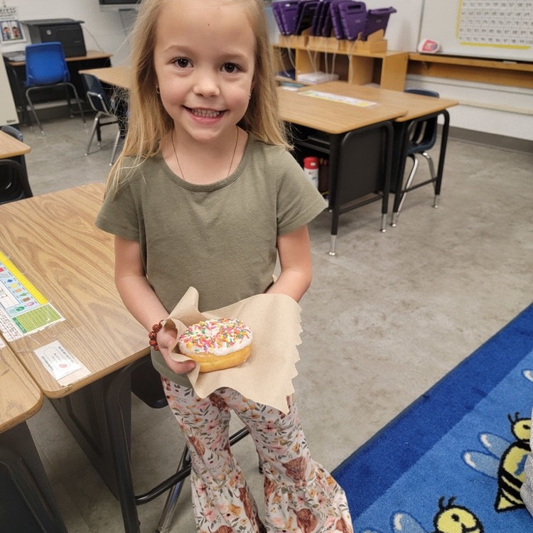 Student holding a prize for reading