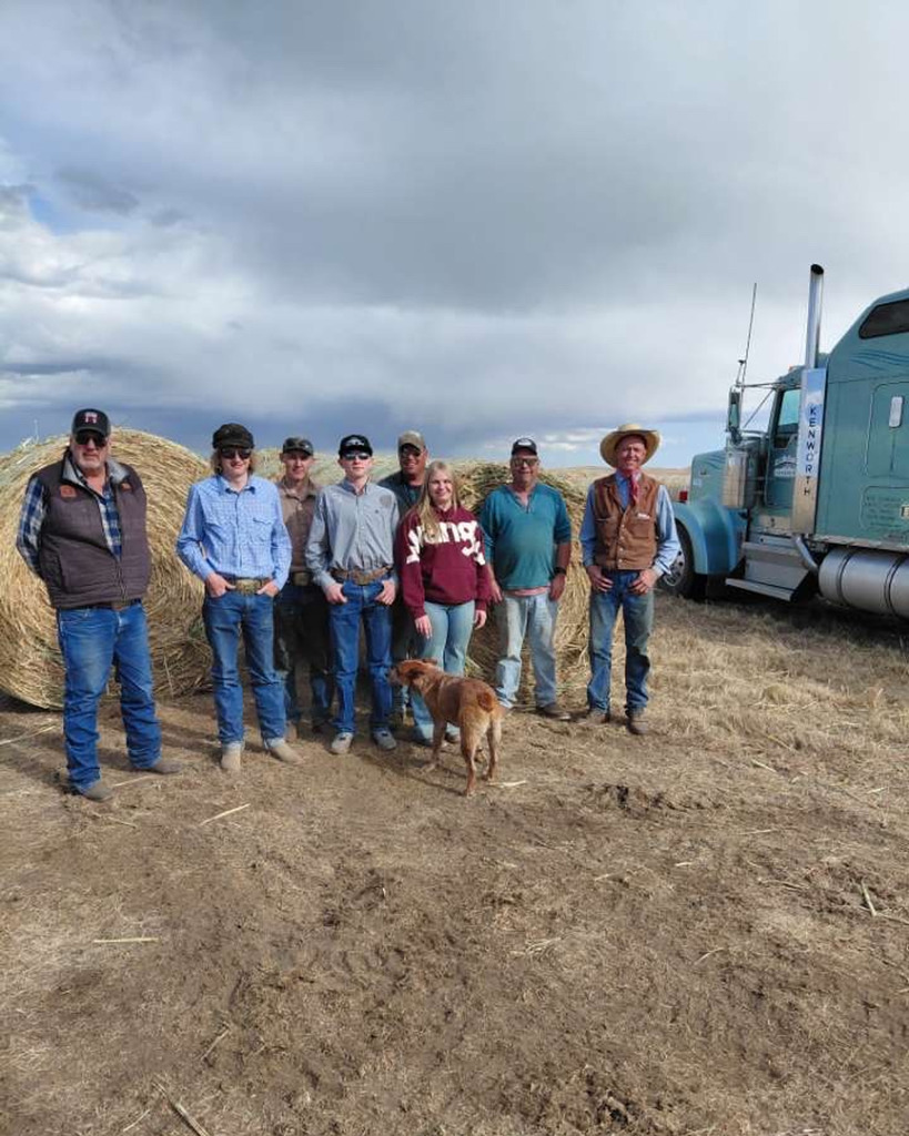 People standing by hay bales