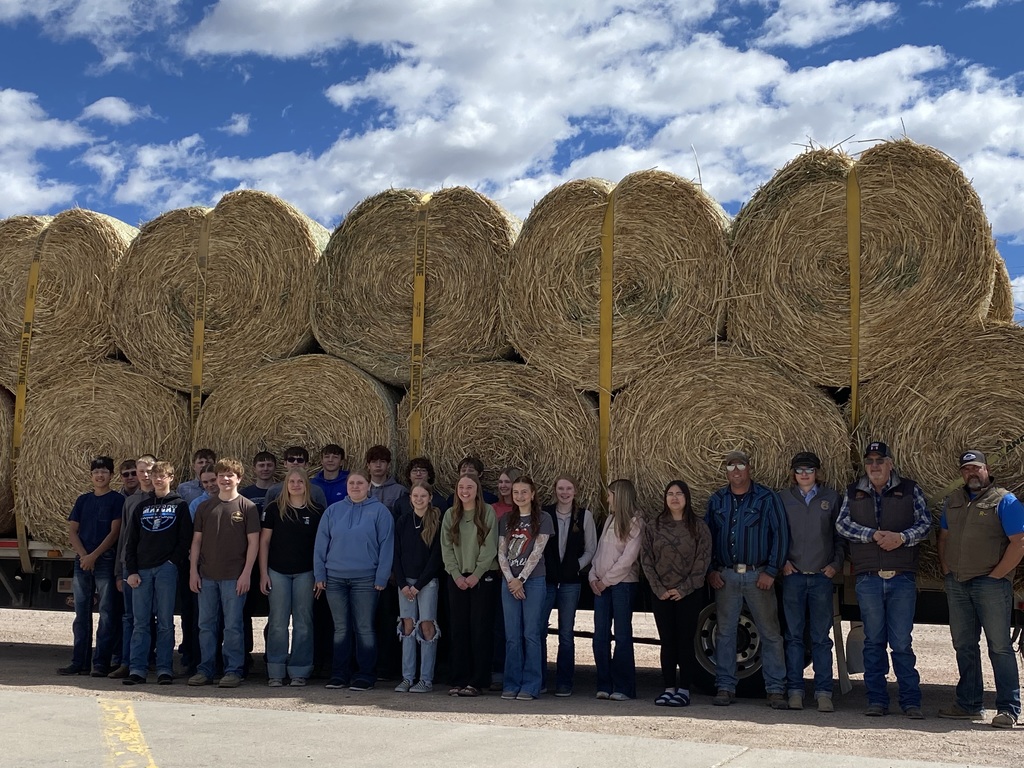 People standing by hay bales