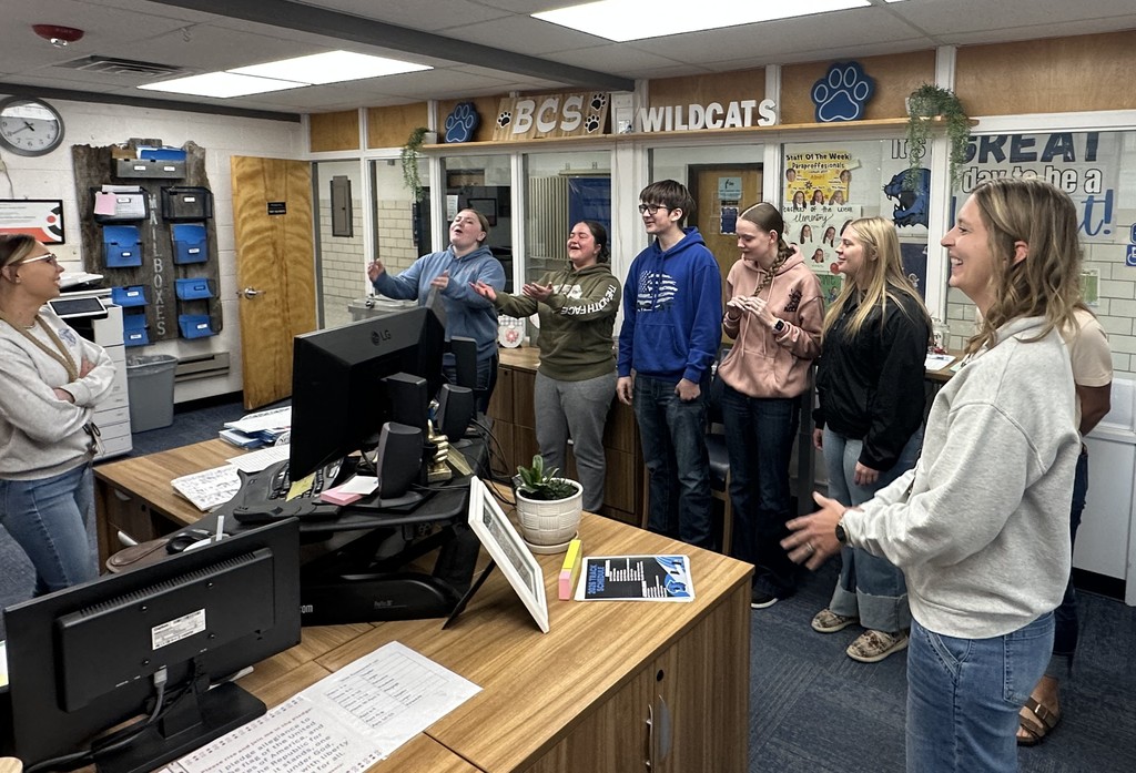 Students singing happy birthday to our secretary 