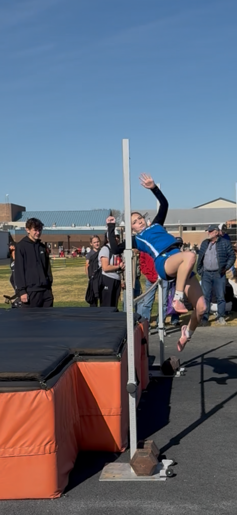 Student Jumping over the high Jump Bar 