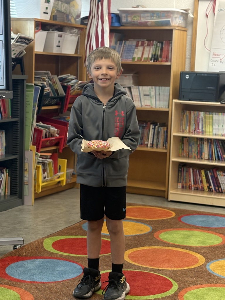 Student holding a prize for reading