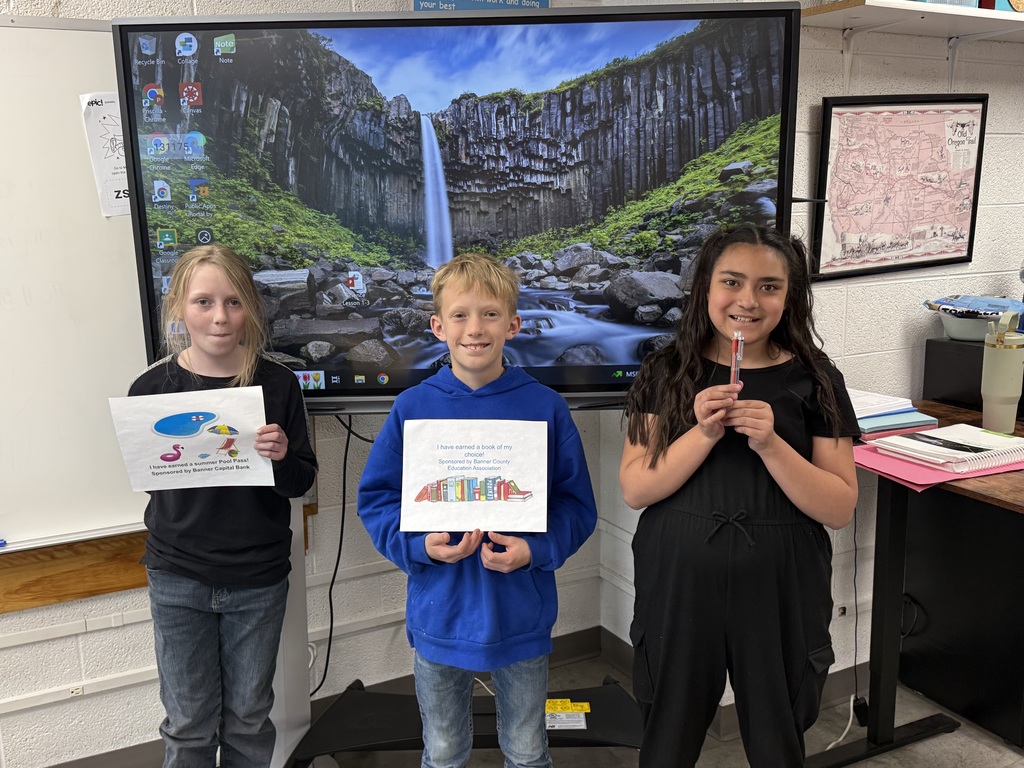 Student holding a prize for reading